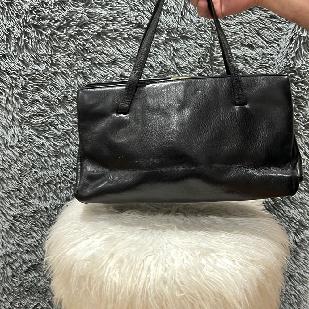 Black leather clamp closure bag